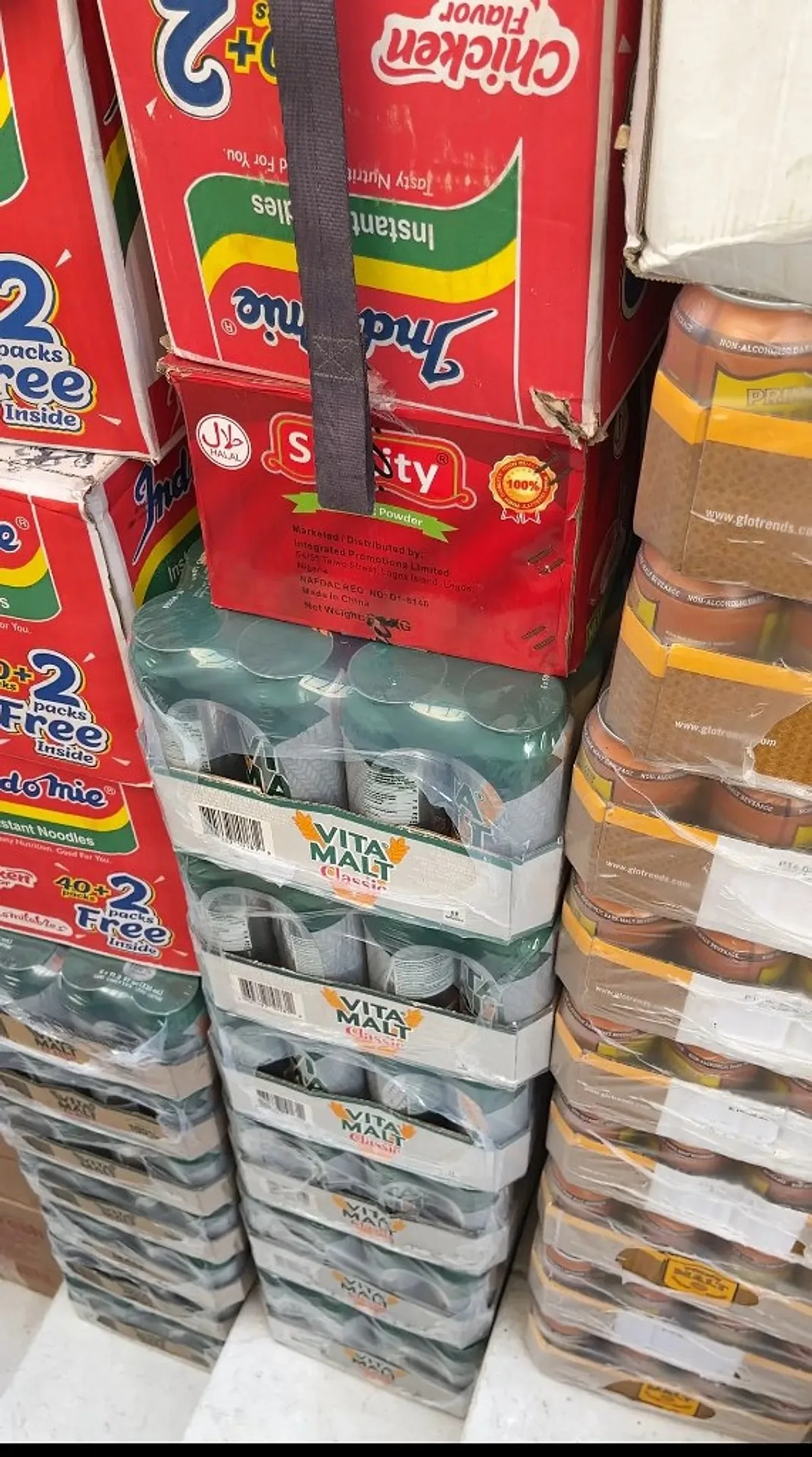 Stacks of Indomie noodles and Vita Malt drinks